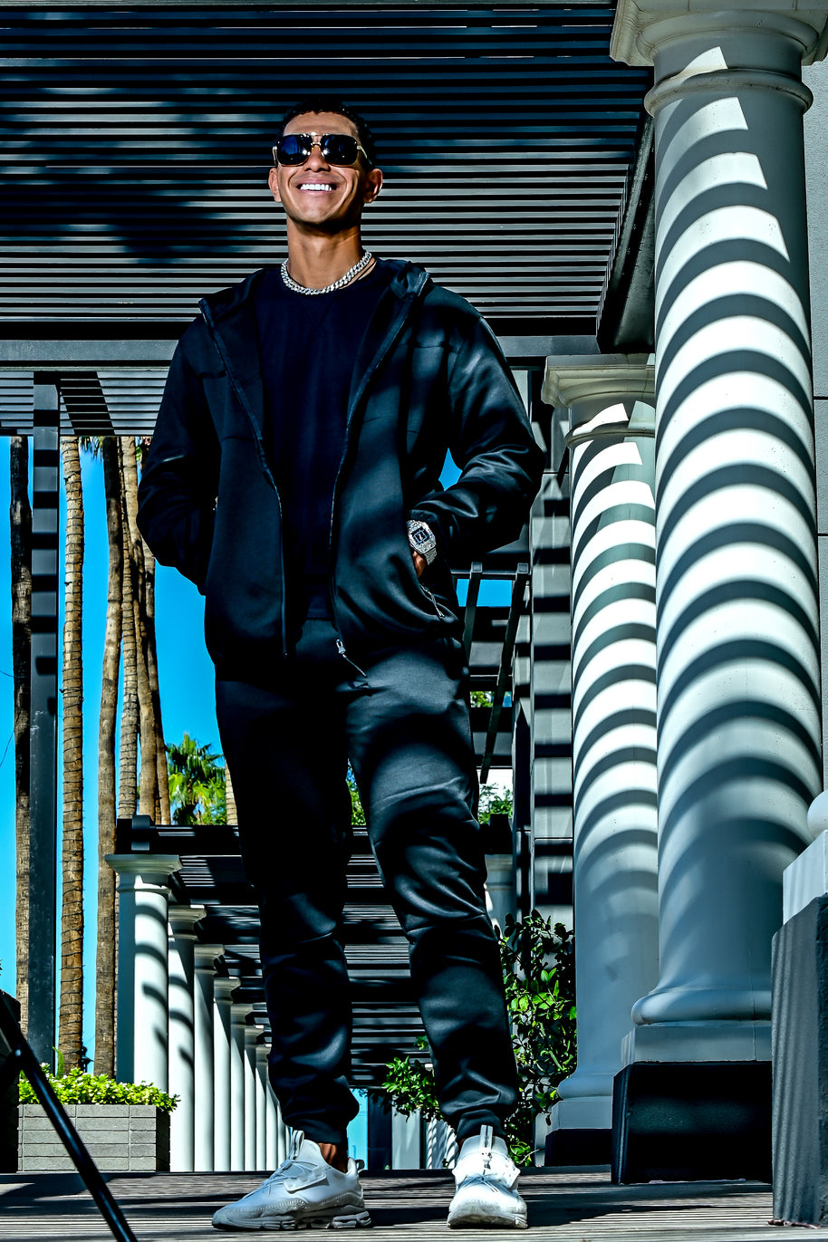 Men’s black Midnight Motion sweatsuit in motion, zip hoodie and jogger set with modern athletic fit