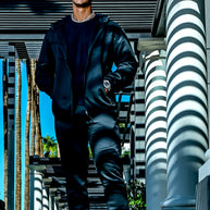Men’s black Midnight Motion sweatsuit in motion, zip hoodie and jogger set with modern athletic fit