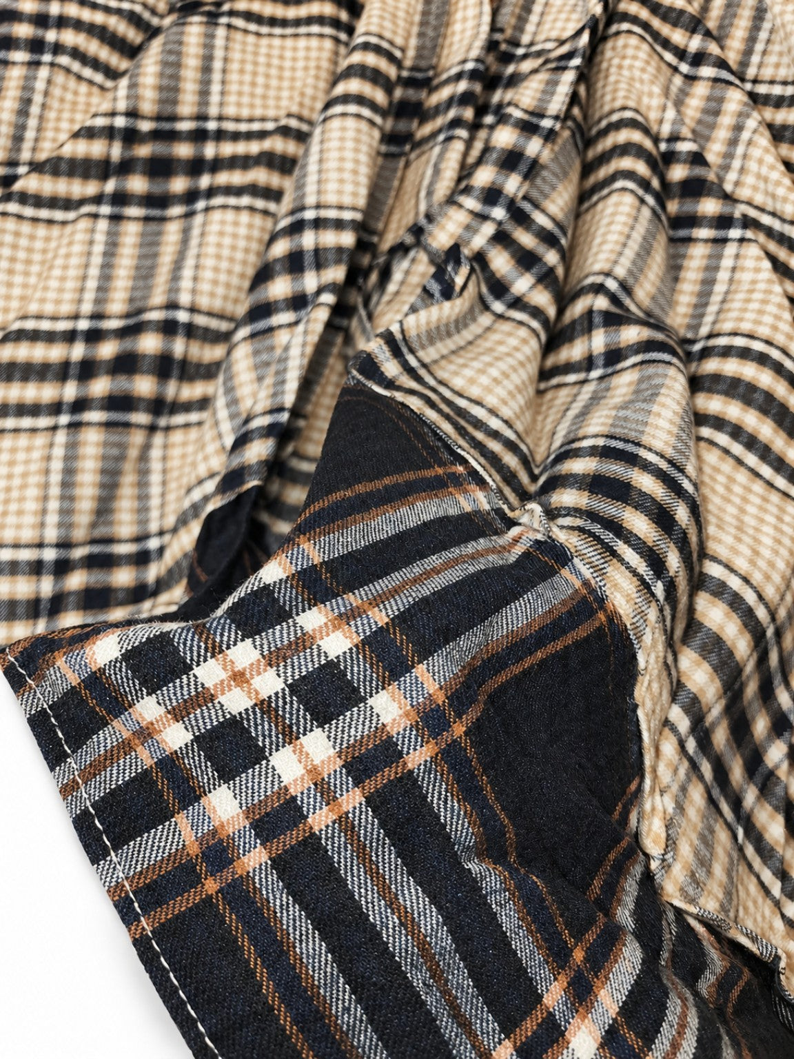 Actual close-up of brown cream and black plaid fabric and dark contrast hem on CianniJ's Plaid Statement Skirt