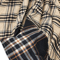 Actual close-up of brown cream and black plaid fabric and dark contrast hem on CianniJ's Plaid Statement Skirt