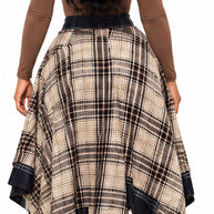 Back model view of brown plaid asymmetrical skirt styled with brown boots