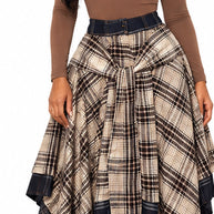 Front model view of brown plaid asymmetrical skirt styled with chocolate bodysuit and boots