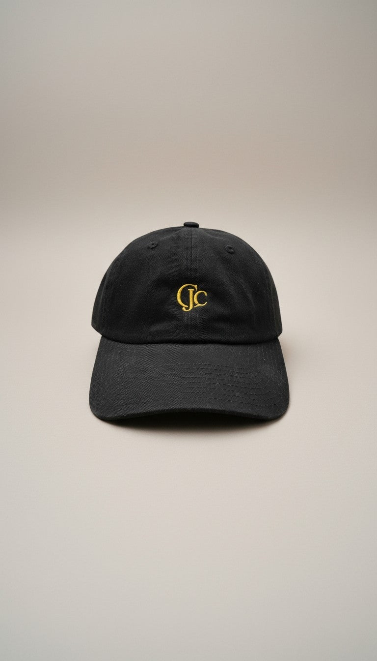 Front view of the CianniJ's CJC Black Twill Hat featuring an embroidered CJC monogram, structured crown, and adjustable buckle closure.
