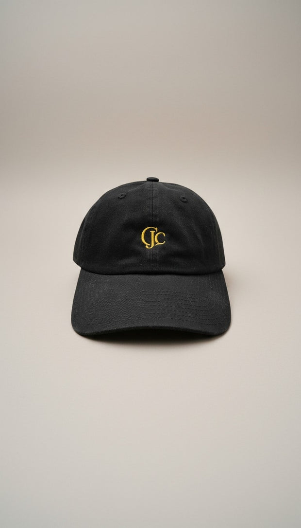 Front view of the CianniJ's CJC Black Twill Hat featuring an embroidered CJC monogram, structured crown, and adjustable buckle closure.
