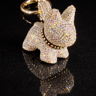 Crystal French Bulldog keychain and purse charm with polished gold-tone hardware on a black reflective background.