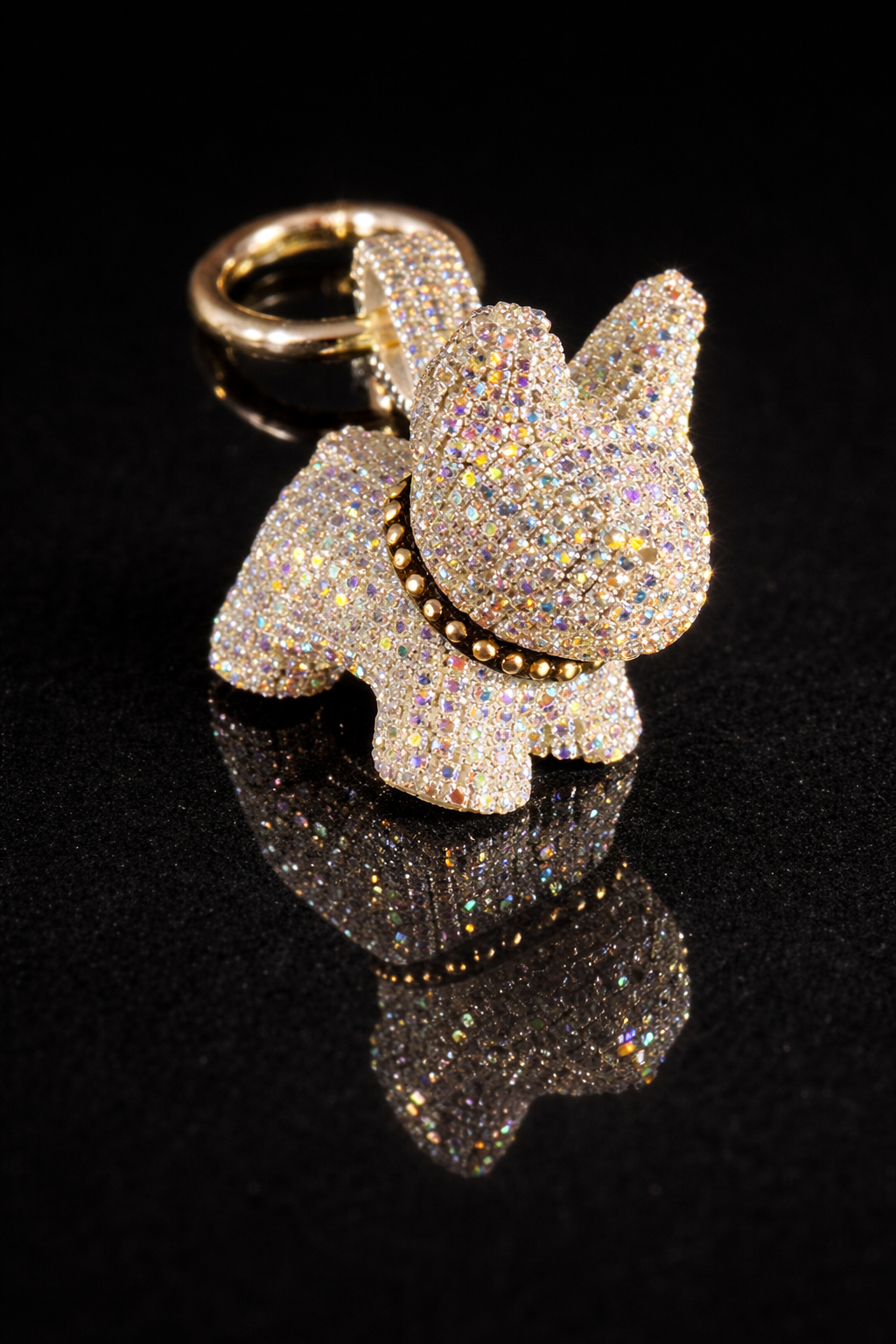 Crystal French Bulldog keychain and purse charm with polished gold-tone hardware on a black reflective background.