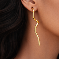 Model wearing Flow Gold Sculptural earrings, showcasing polished gold finish and modern sculptural silhouette.