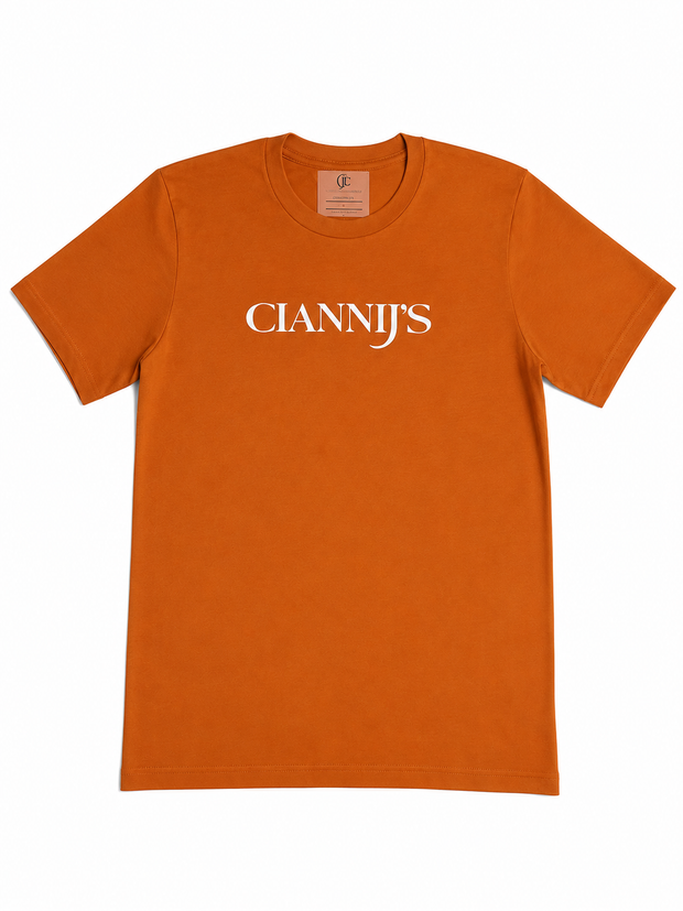 Burnt orange CianniJ's Iconic Tee with white minimalist logo on a premium cotton crew neck T-shirt.