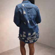 Back view of distressed denim jacket with frayed detailing and structured silhouette